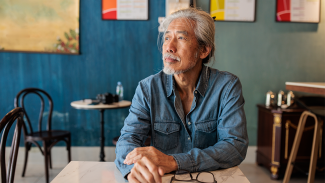 Person sitting at a table pondering their thoughts